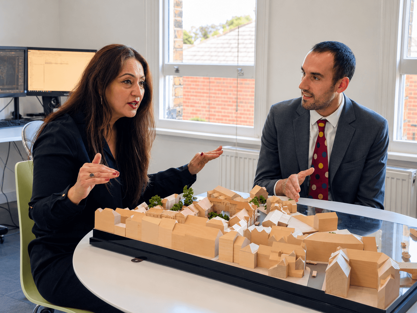 Daniel Gonzalez and Manni Chopra reviewing a development model